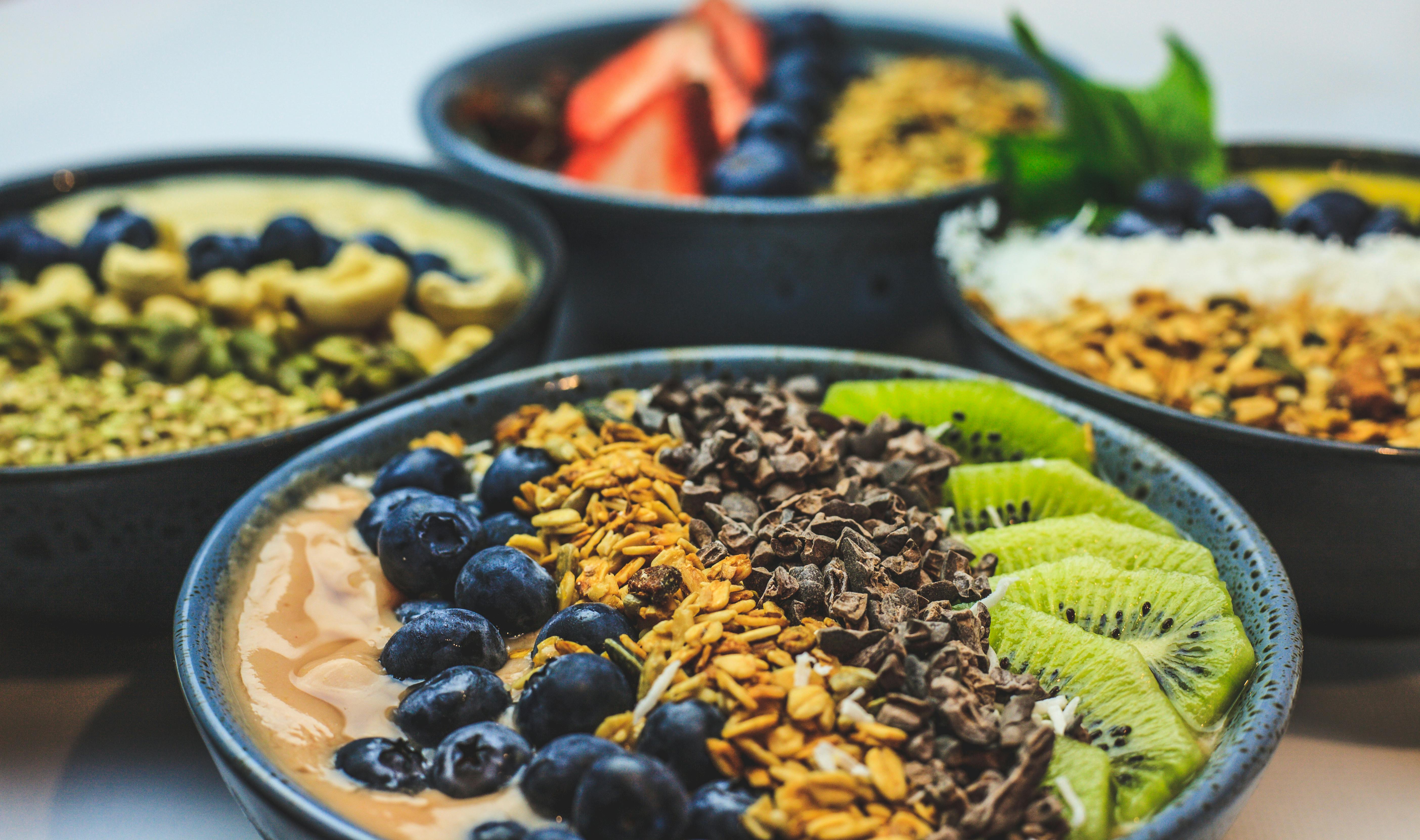 A healthy fruit bowl topped with crunchy Arunachala Cacao nibs