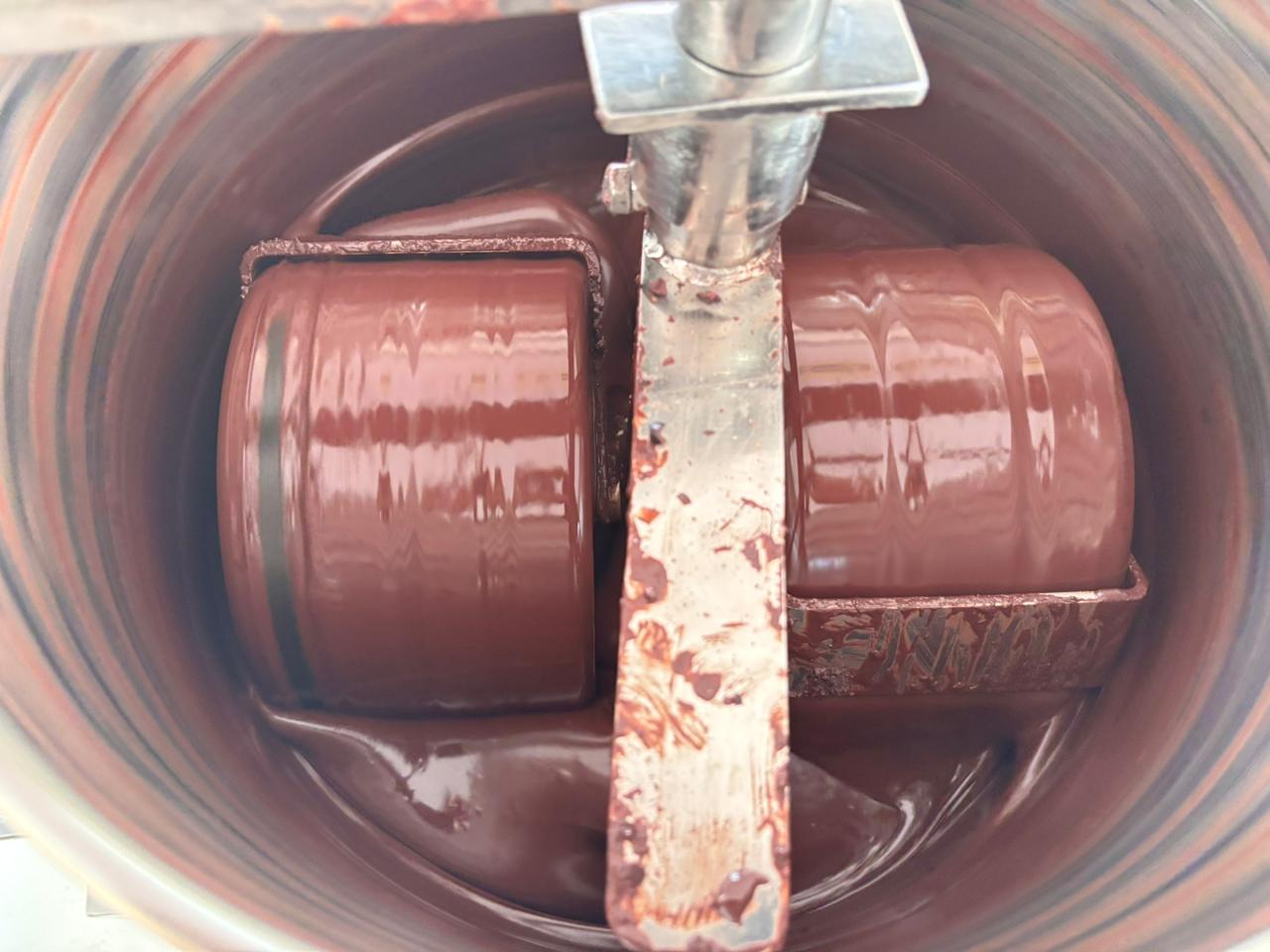 Stone melangers slowly grinding unroasted cacao beans into ceremonial grade cacao mass